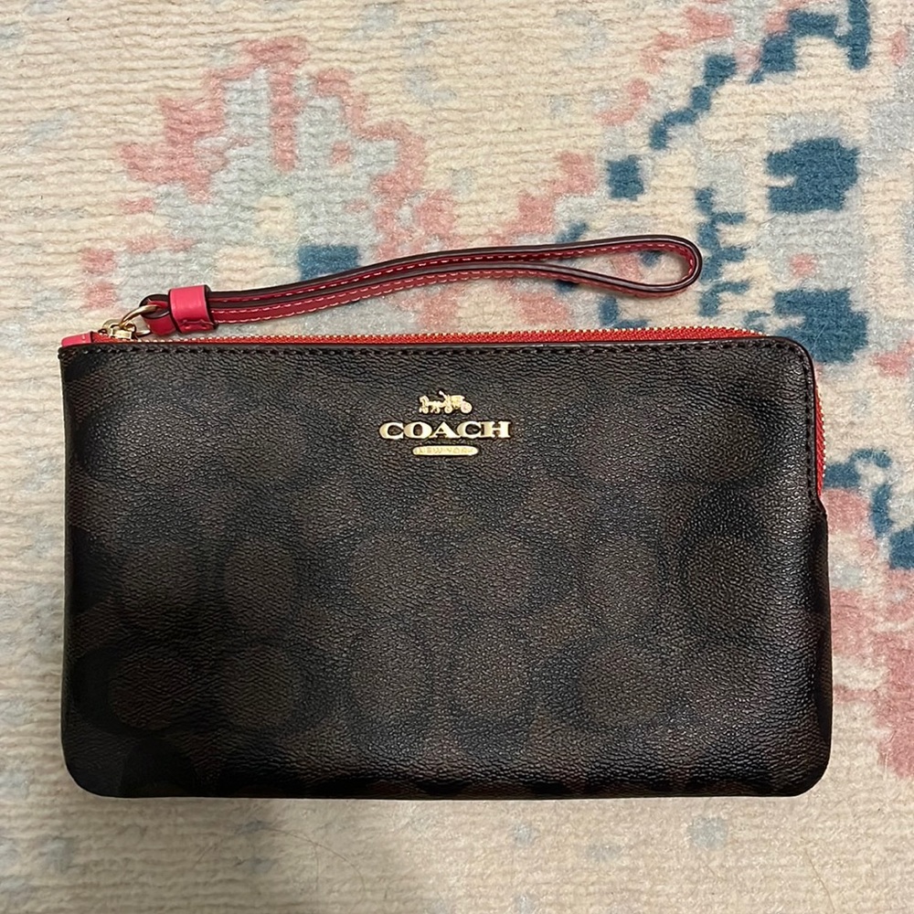Coach wristlet with pink strap